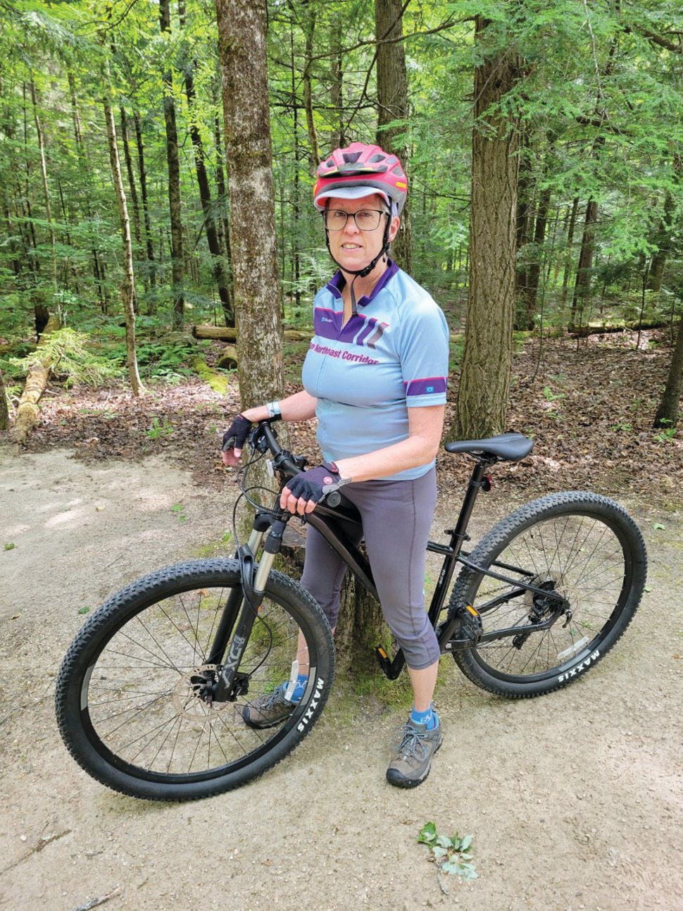 READY TO BIKE: Linda Burrows will participate in this year’s Pan Mass Challenge (PMC) by biking from Wellesley to Patriot Place on a 50-mile route. Her goal each year is to increase the distance she rides within the race. Here she is biking in Vermont three weekends before PMC. (Submitted photo)